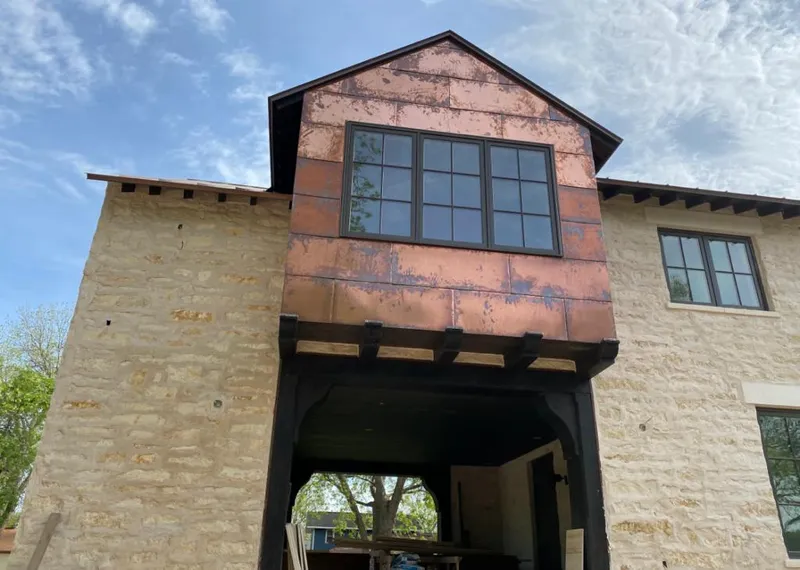 Copper metal panel facade on a stone building for Metal Roof Coating in West Memphis